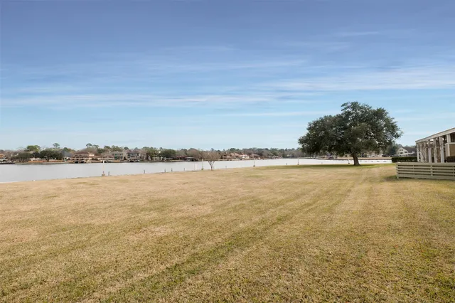 a kitchen with granite countertop a sink a stove and refrigerator