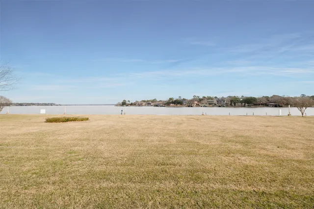 a kitchen with stainless steel appliances granite countertop a sink refrigerator stove and white cabinets