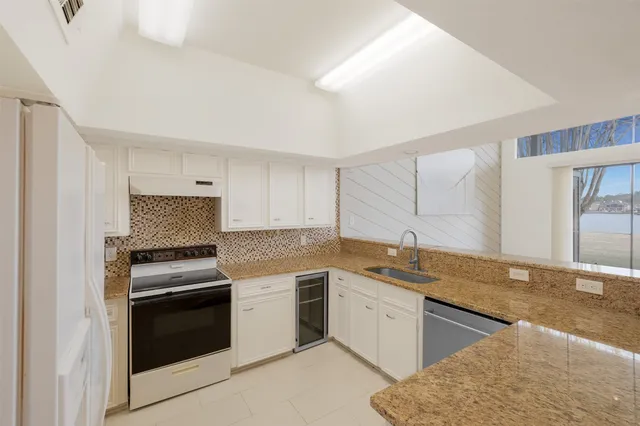 an empty room with closet and a ceiling fan