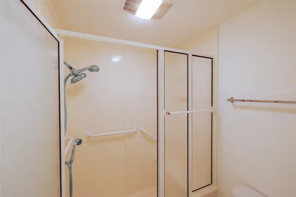 a bathroom with a tub sink vanity and mirror