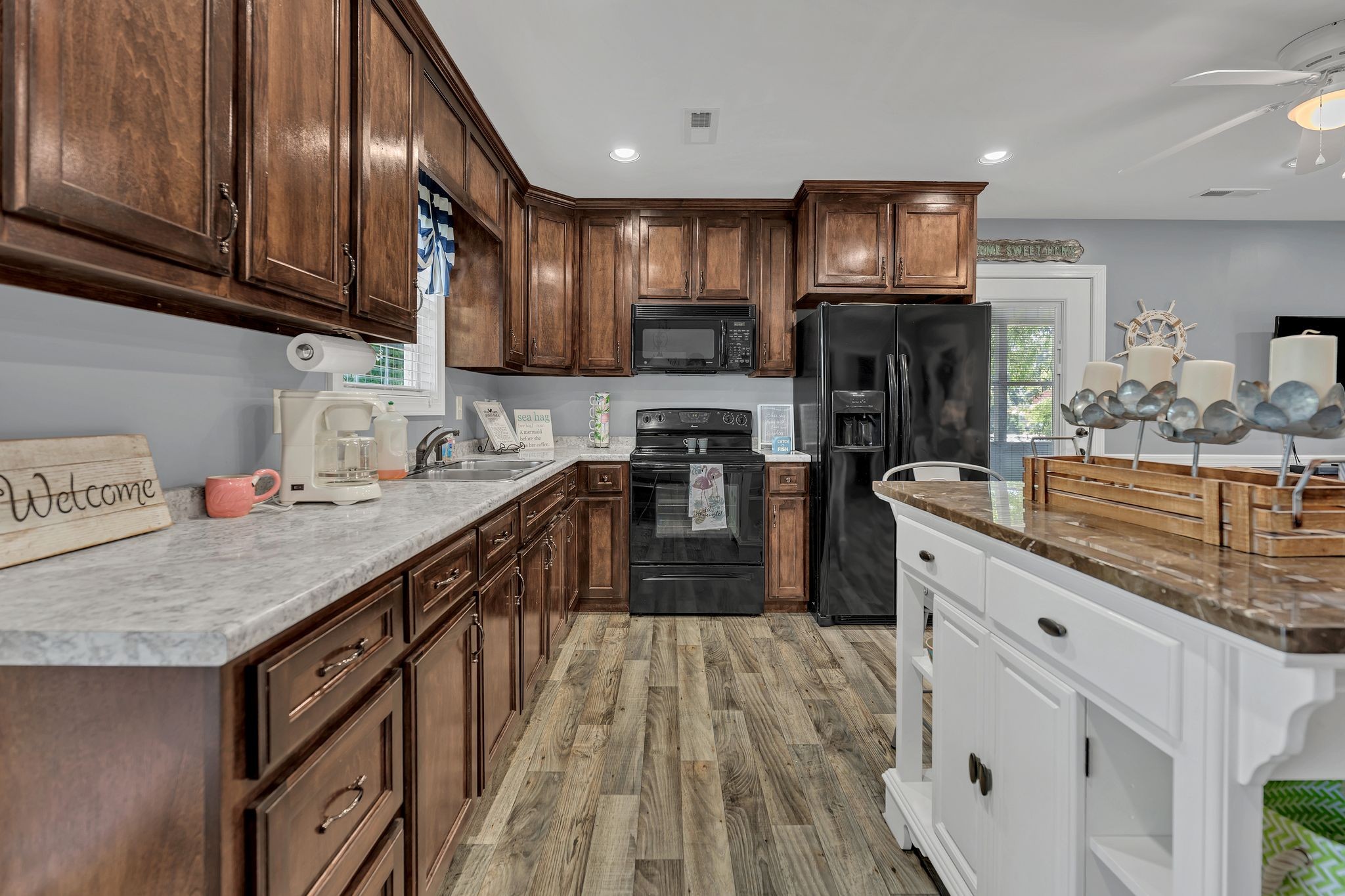 219 Tn River Estates Road Clifton, TN 38425 - Photo 12 of 38 a kitchen with stainless steel appliances granite countertop wooden cabinets a stove top oven a sink and dishwasher