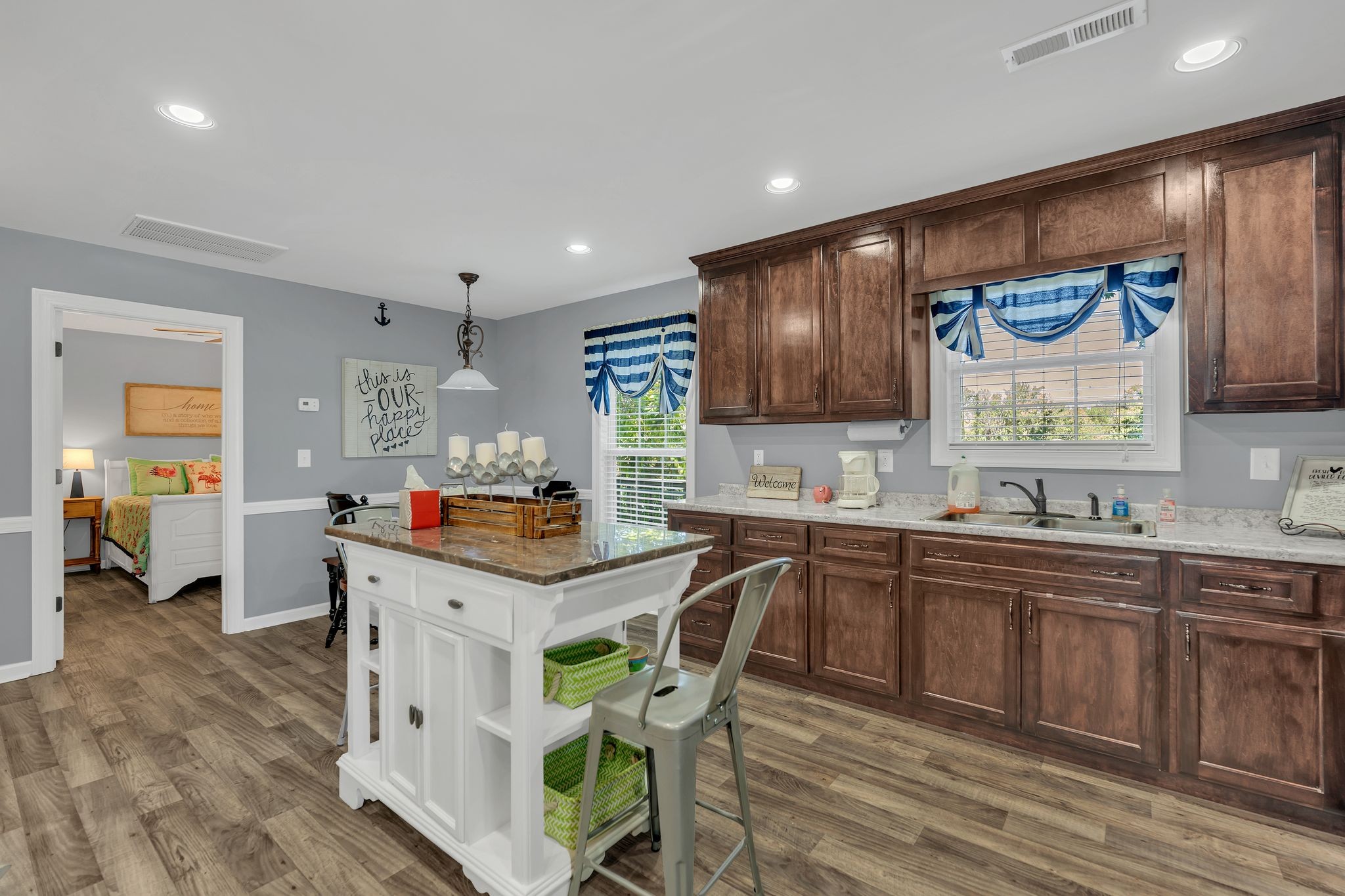 219 Tn River Estates Road Clifton, TN 38425 - Photo 16 of 38 a kitchen with stainless steel appliances granite countertop a table chairs sink and cabinets
