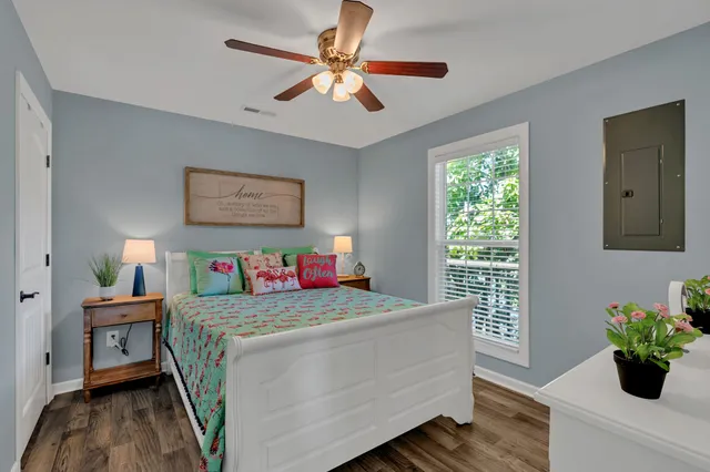 a bedroom with a bed and a chandelier