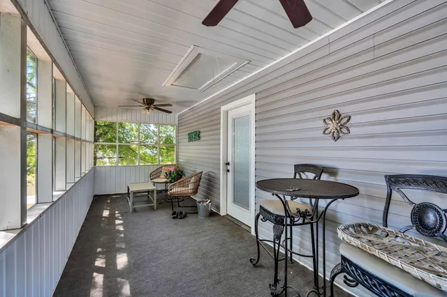 a view of a patio with chairs and table