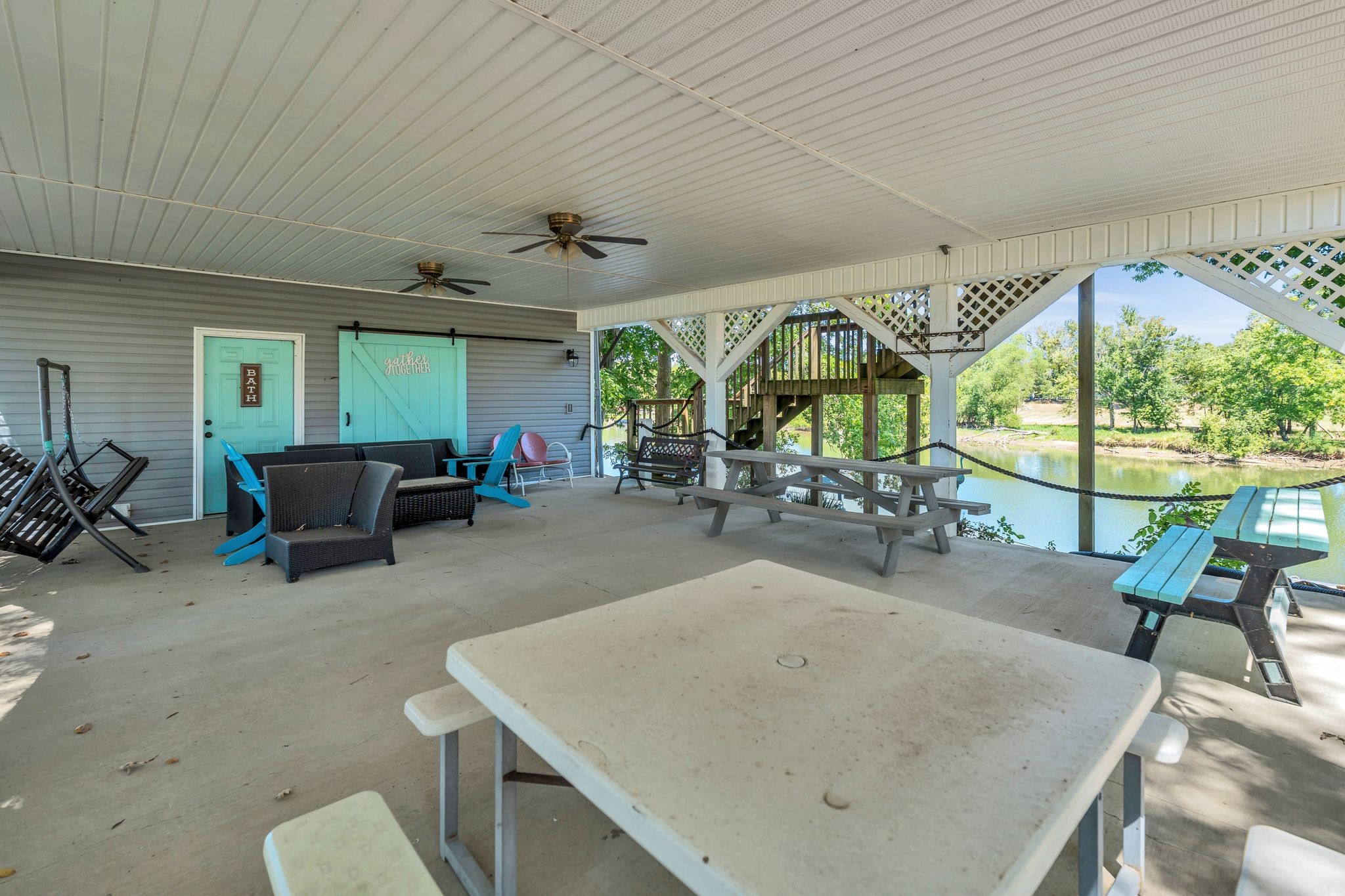 219 Tn River Estates Road Clifton, TN 38425 - Photo 29 of 38 a view of a dining room with furniture large windows and wooden floor