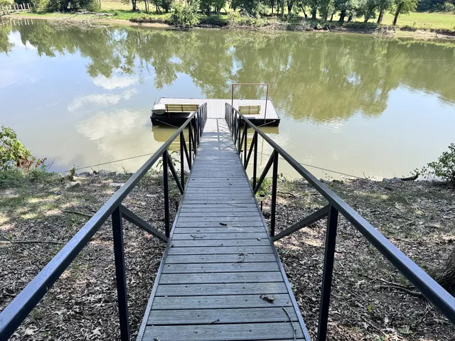 a view of a balcony with wooden floor and lake view