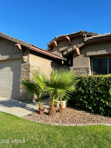 a view of a backyard with plants and patio