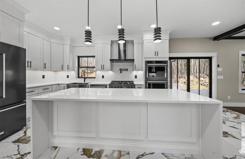 346 Shawanga Lodge Road Bloomingburg, NY 12721 - Photo 11 of 36 Kitchen with appliances with stainless steel finishes, plenty of natural light, sink, and wall chimney range hood