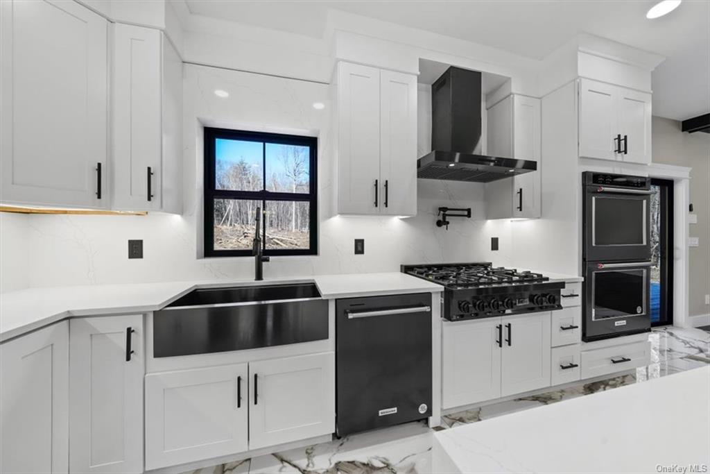 346 Shawanga Lodge Road Bloomingburg, NY 12721 - Photo 13 of 36 Kitchen with white cabinetry, tasteful backsplash, wall chimney exhaust hood, black appliances, and sink
