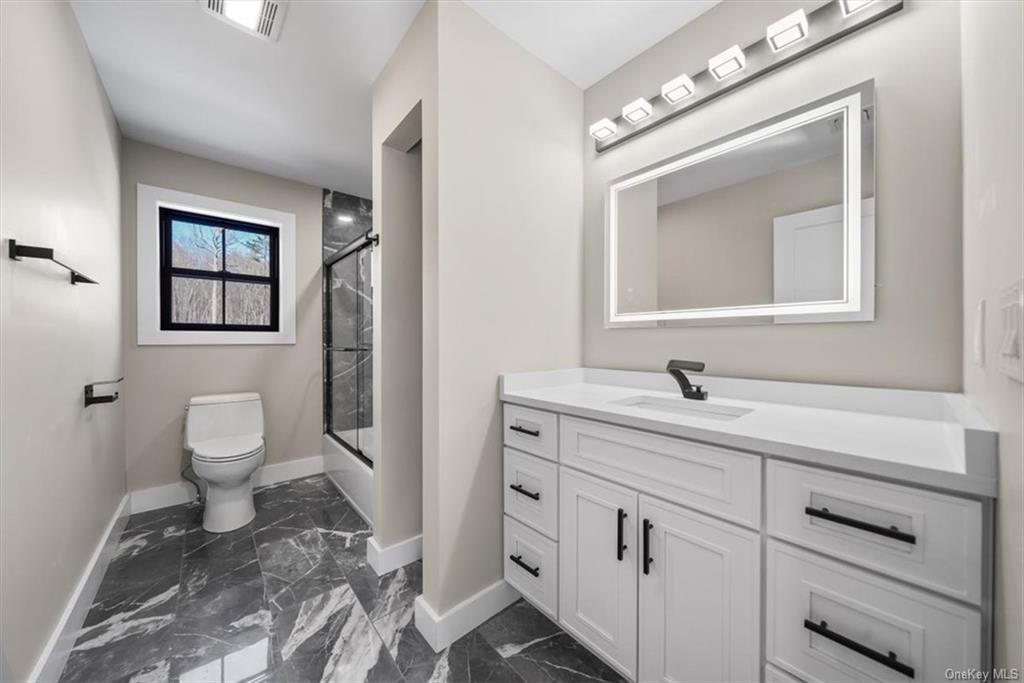 346 Shawanga Lodge Road Bloomingburg, NY 12721 - Photo 24 of 36 Full bathroom with combined bath / shower with glass door, vanity, and toilet