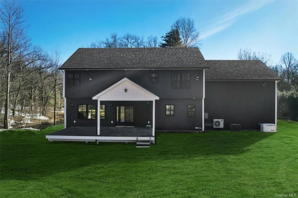 346 Shawanga Lodge Road Bloomingburg, NY 12721 - Photo 34 of 36 Rear view of property featuring a lawn, a wooden deck, and central AC unit