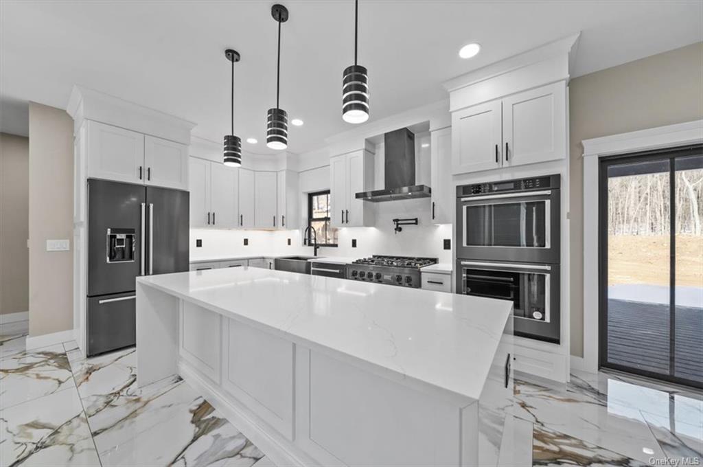 346 Shawanga Lodge Road Bloomingburg, NY 12721 - Photo 10 of 36 Kitchen featuring appliances with stainless steel finishes, light stone countertops, wall chimney range hood, and white cabinets