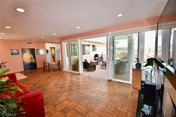 a view of a living room and a balcony
