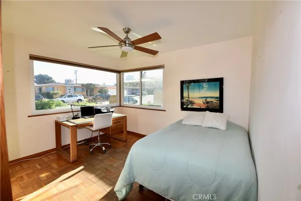a bedroom with a bed and a large window