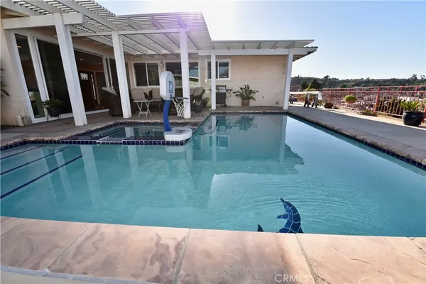 a view of a swimming pool and lounge chair