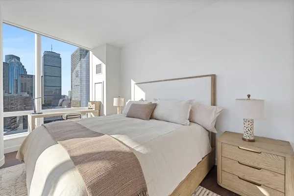 a bedroom with a bed and with a mirror