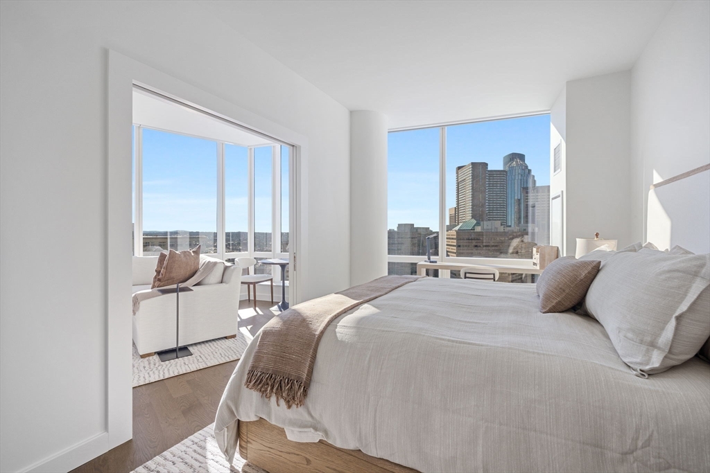 40 Trinity Place, Unit 1508 Boston, MA 02116 - Photo 5 of 19 a bedroom with a bed and large window