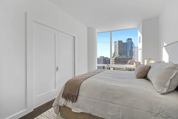 a bedroom with a bed and a mirror