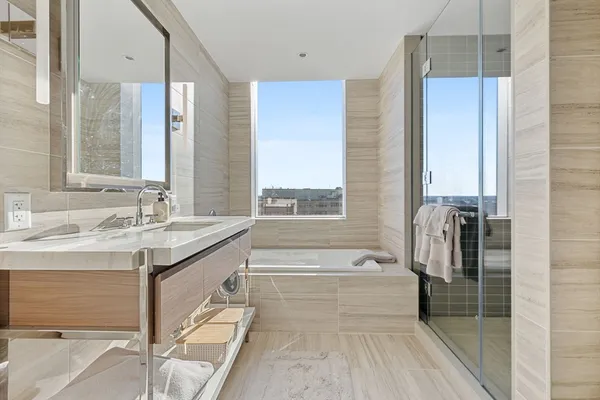 a spacious bathroom with a granite countertop tub sink and mirror
