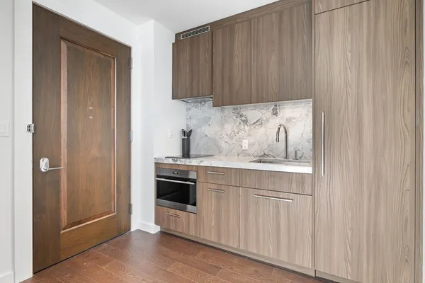 a kitchen with granite countertop white cabinets and stainless steel appliances