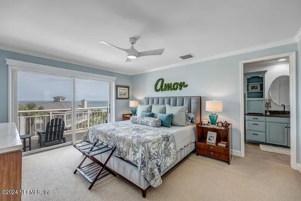 a bedroom with a bed furniture and a flat screen tv