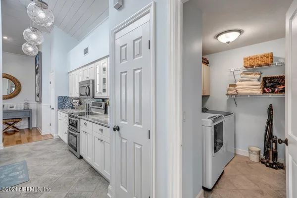 a kitchen with cabinets and stainless steel appliances