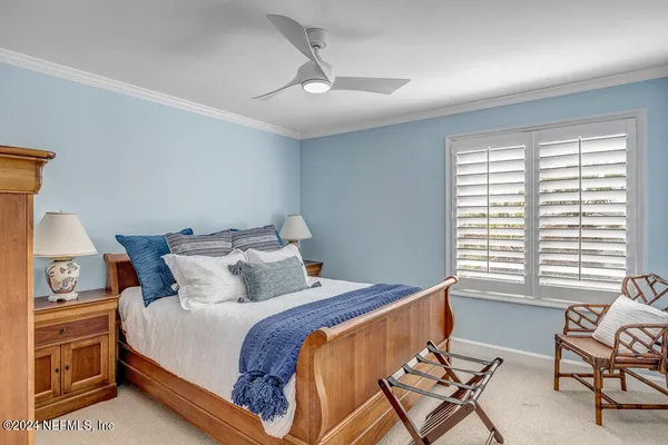 a bedroom with a bed and a chair