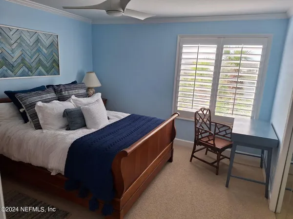 a bed room with a bed and a chair