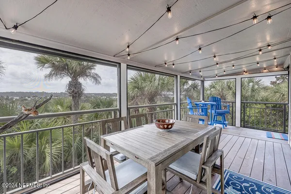 a view of a balcony with table and chairs