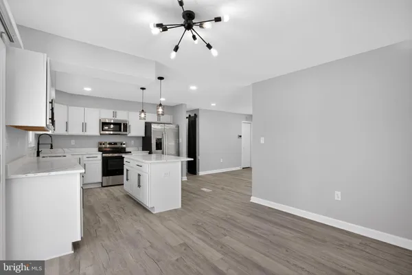 a view of a kitchen with microwave and stove top oven