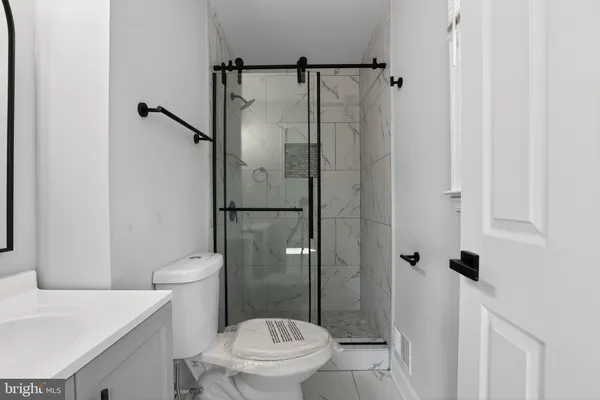 a white toilet sitting next to a bathroom sink