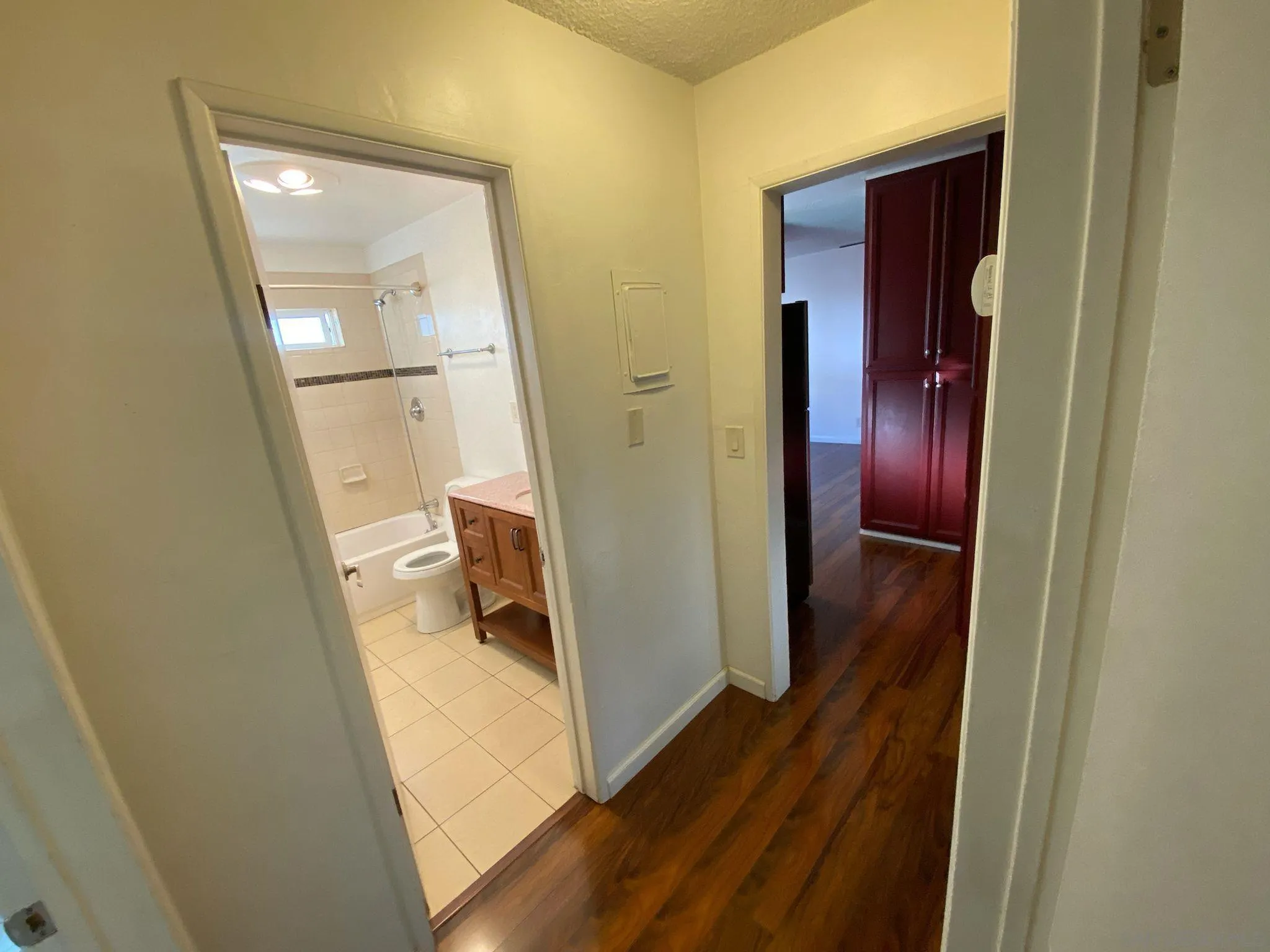 253 North Cedar Street Escondido, CA 92025 - Photo 12 of 18 a view of a hallway with wooden floor and a living room
