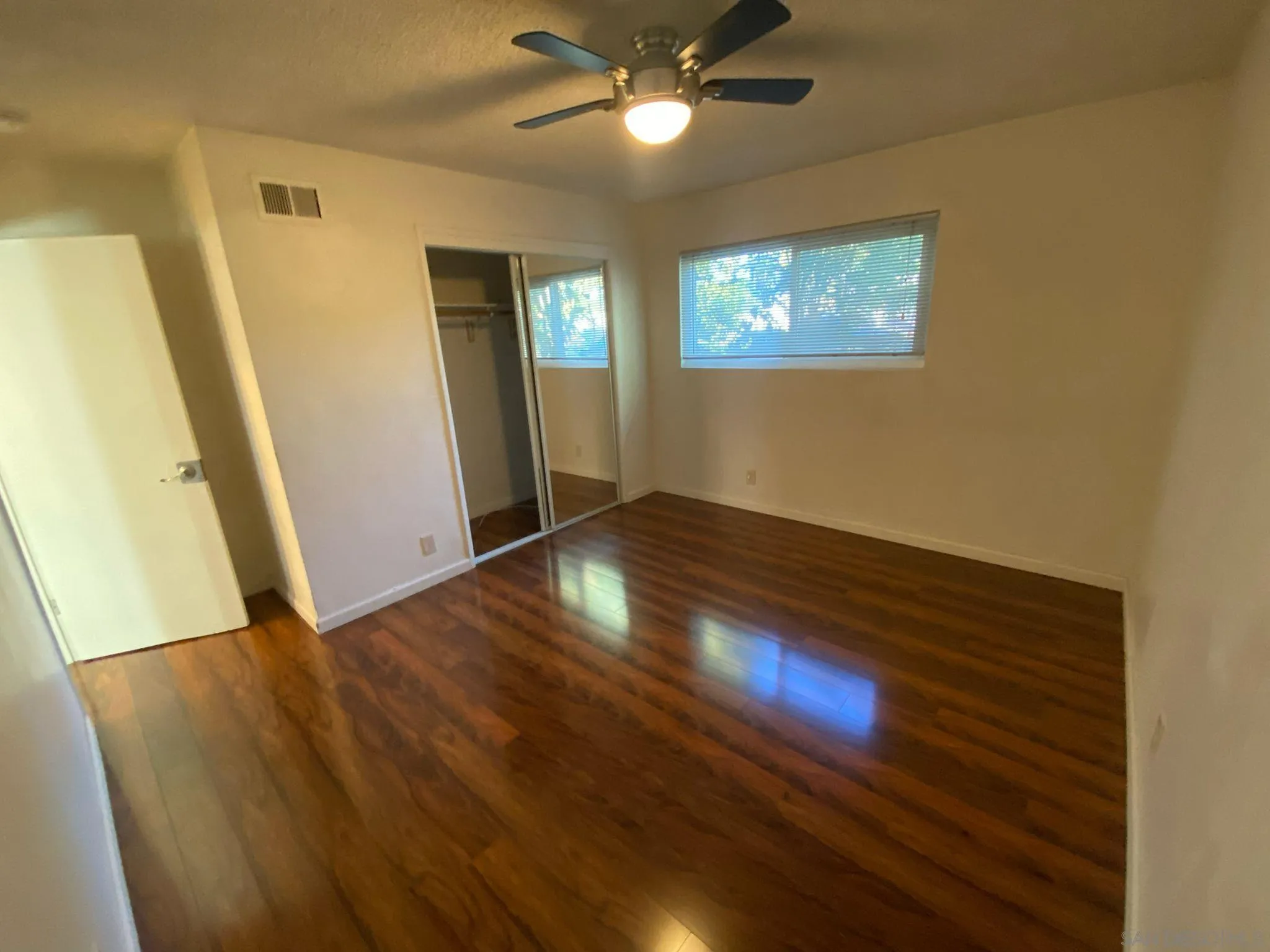 253 North Cedar Street Escondido, CA 92025 - Photo 13 of 18 a view of an empty room with wooden floor and a window
