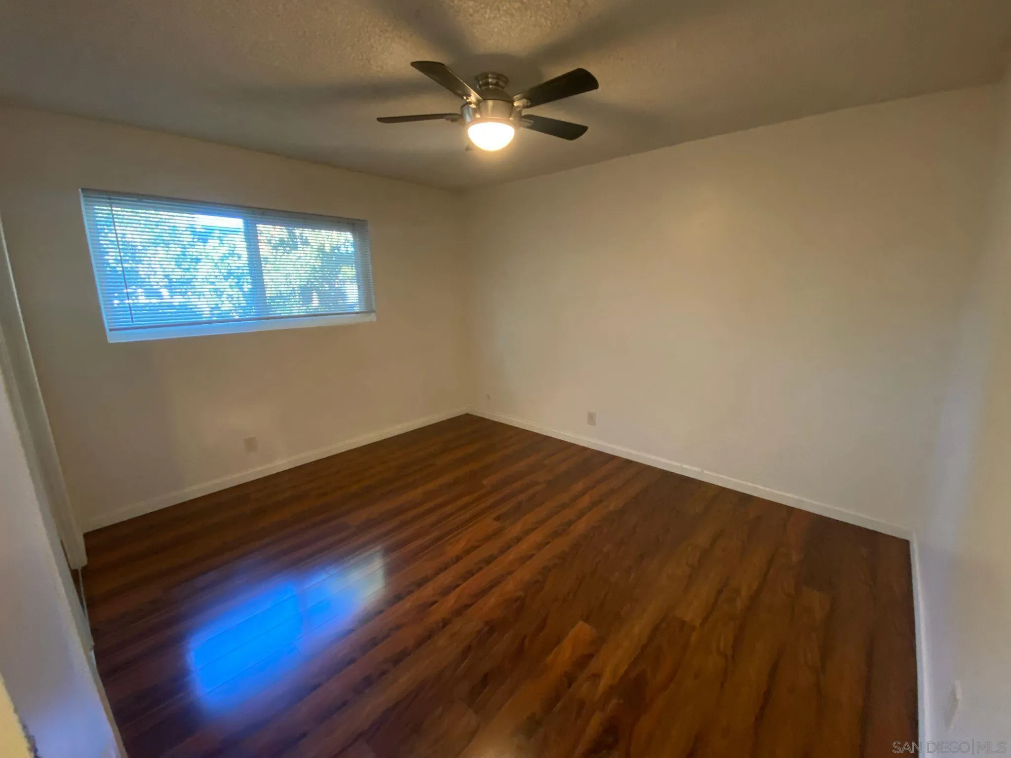 253 North Cedar Street Escondido, CA 92025 - Photo 14 of 18 en empty room with wooden floor and fan