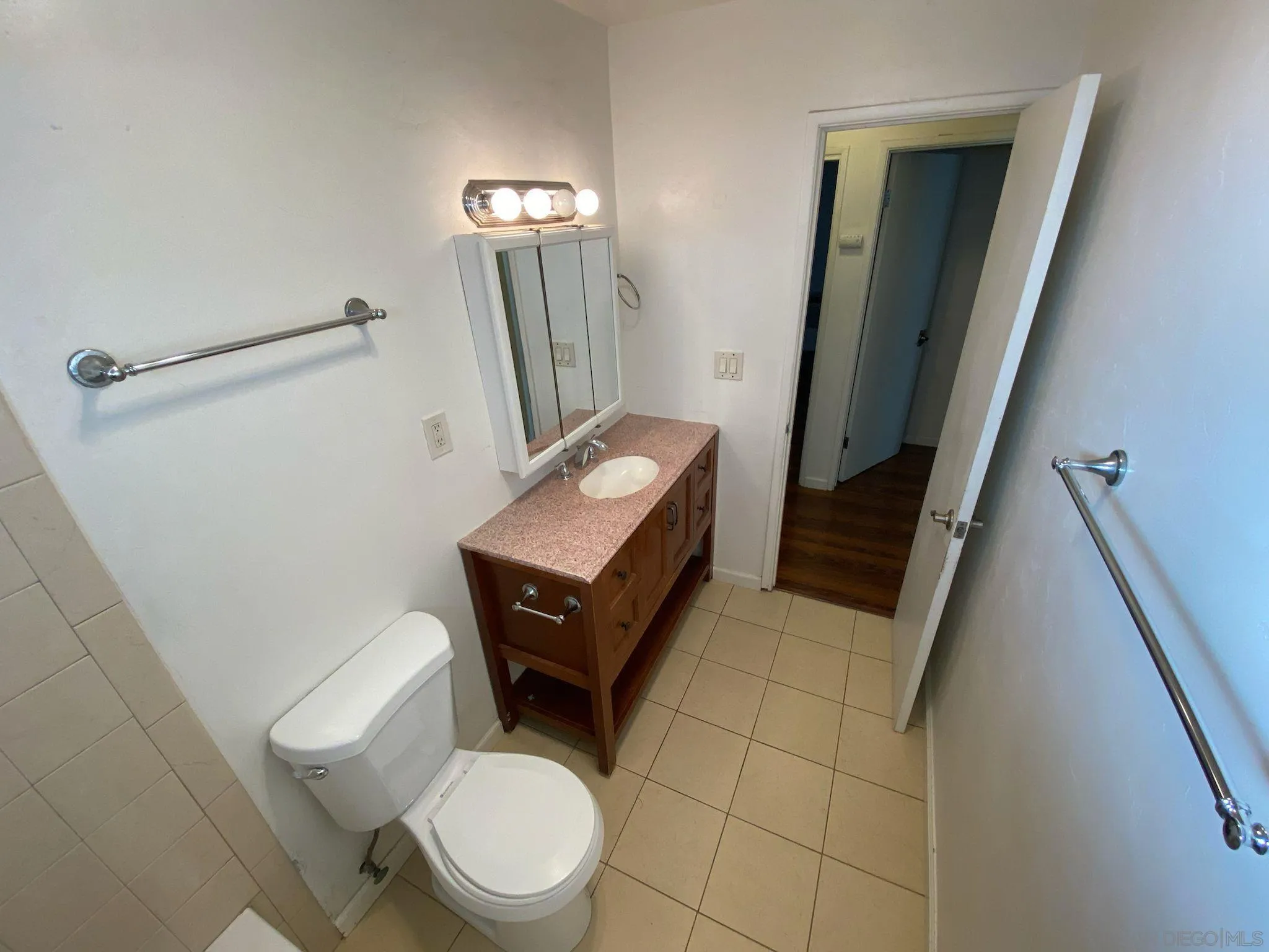253 North Cedar Street Escondido, CA 92025 - Photo 17 of 18 a bathroom with a toilet a sink and mirror