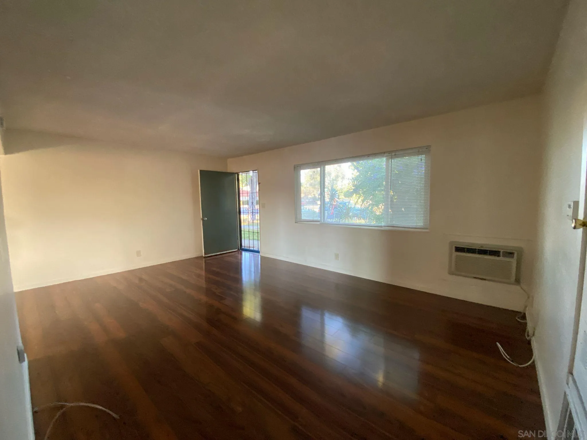 253 North Cedar Street Escondido, CA 92025 - Photo 4 of 18 an empty room with wooden floor and windows
