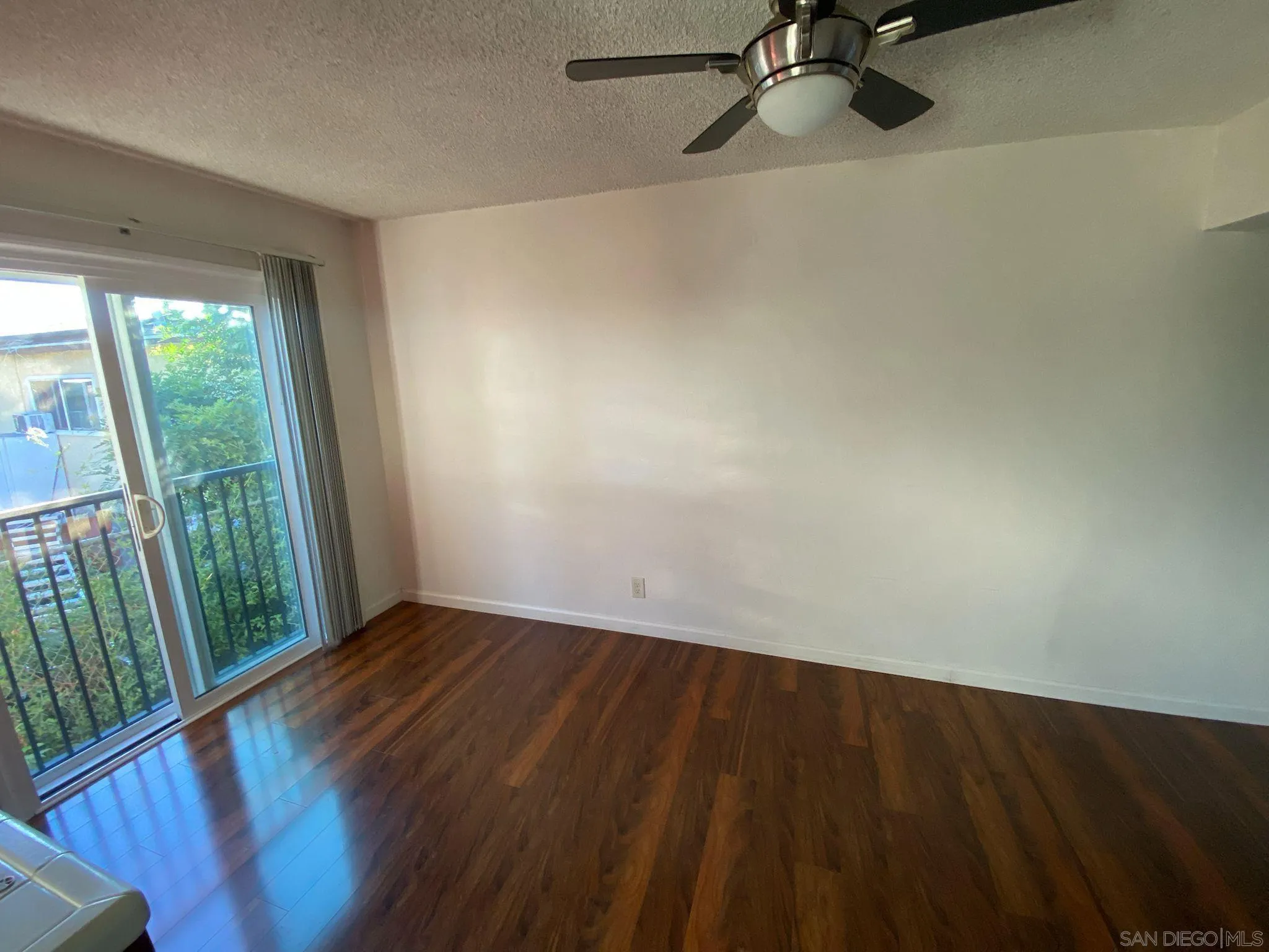 253 North Cedar Street Escondido, CA 92025 - Photo 8 of 18 a view of a room with a wooden floor and a window