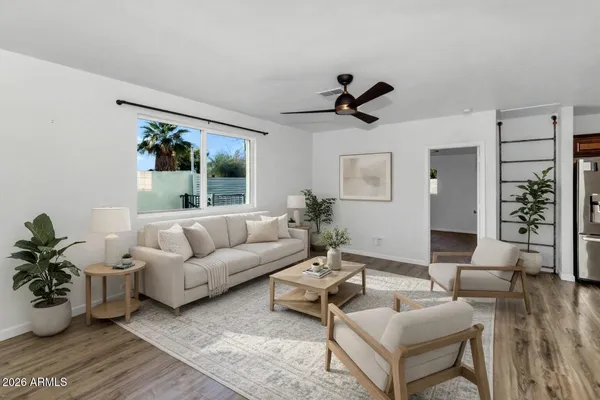 a living room with furniture and wooden floor