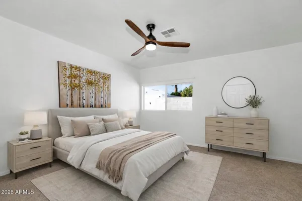 a bedroom with a bed and window