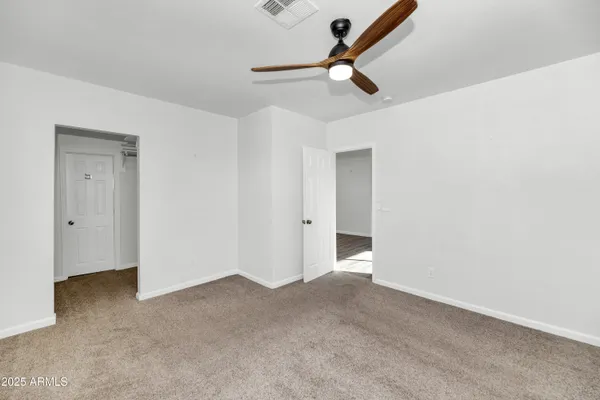 a view of a room with a ceiling fan