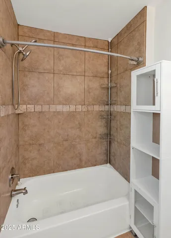 a bathroom with a bathtub and a shower