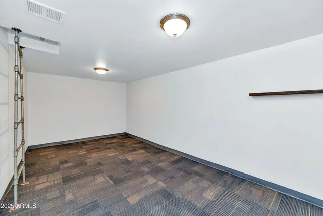 a view of walk in closet with wooden floor