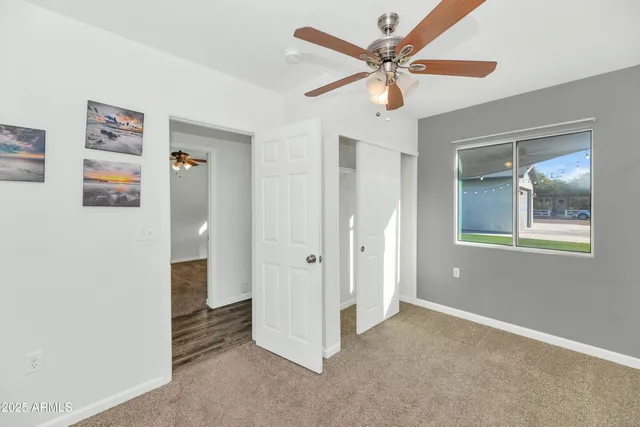 a view of an empty room with window and cabinet