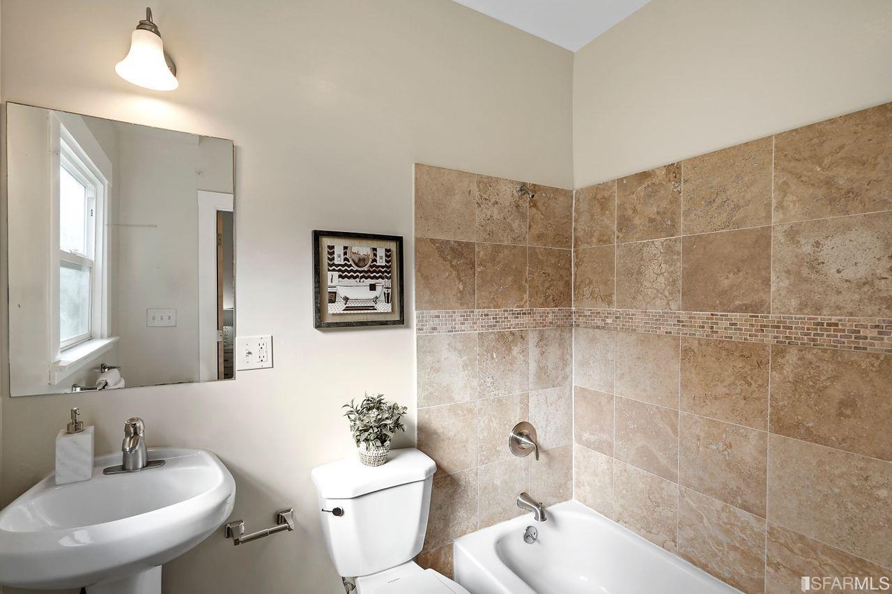 3036 14th Avenue Oakland, CA 94602 - Photo 15 of 35 a bathroom with a toilet sink shower and mirror