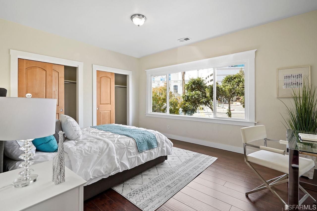 3036 14th Avenue Oakland, CA 94602 - Photo 5 of 35 a bedroom with a bed and large windows