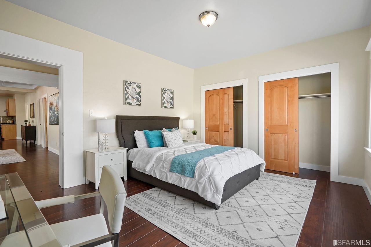3036 14th Avenue Oakland, CA 94602 - Photo 6 of 35 a bedroom with a large bed and a wooden floor