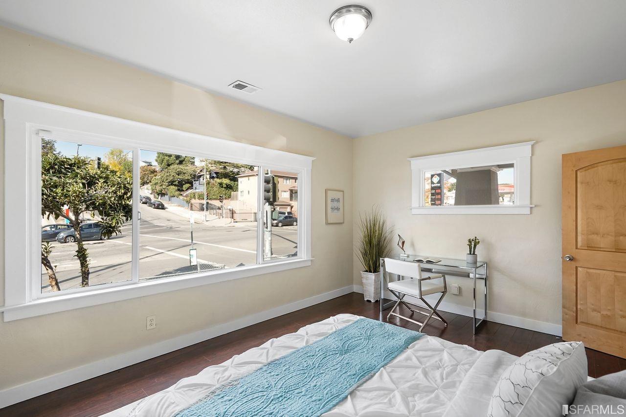 3036 14th Avenue Oakland, CA 94602 - Photo 8 of 35 a living room with furniture and a large window