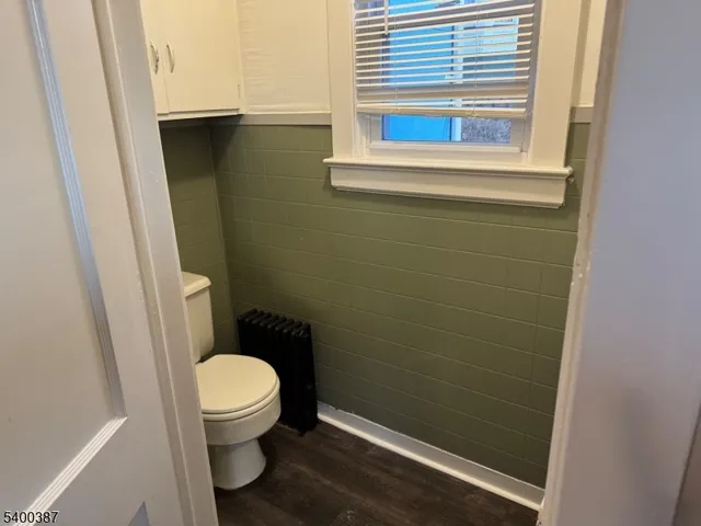 a bathroom with a toilet and a window