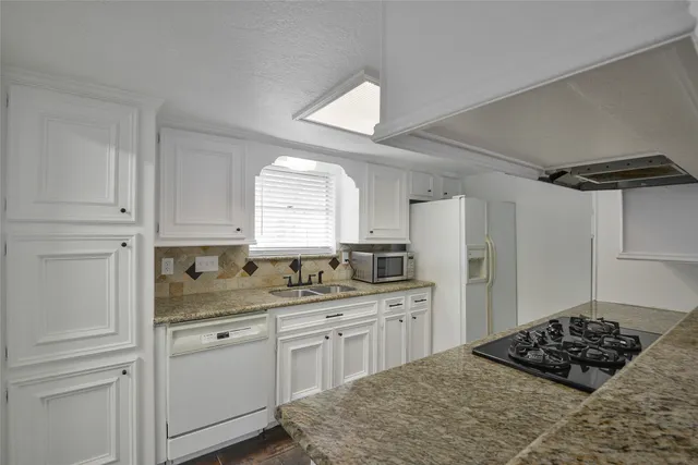 a kitchen with a sink stove and refrigerator