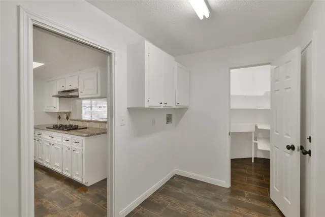 a kitchen with granite countertop a stove and a sink